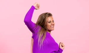 front view young woman posing rejoicing beautiful purple dress pink wall jpg