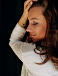 close up portrait attractive pretty woman with tanned skin is touching her hair smiling with closed eyes jpg