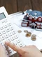 female hand operating calculator front villa house model jpg
