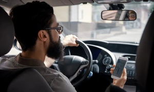 man using mobile phone while driving jpg