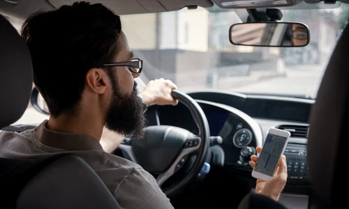 man using mobile phone while driving jpg