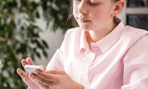 little girl checking her phone online class jpg
