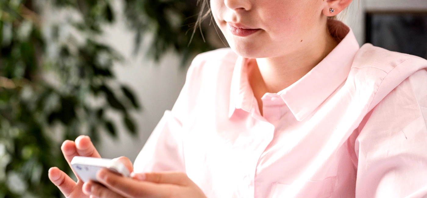 little girl checking her phone online class jpg