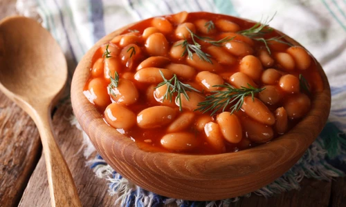 white beans in tomato sauce in a wooden bowl jpeg