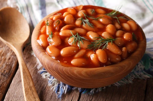 white beans in tomato sauce in a wooden bowl jpeg