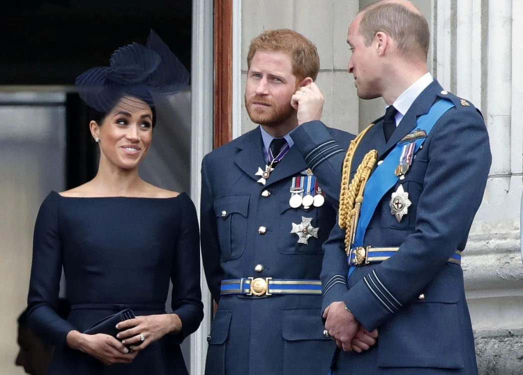 Meghan zâmbește alături de Prinții Harry și William