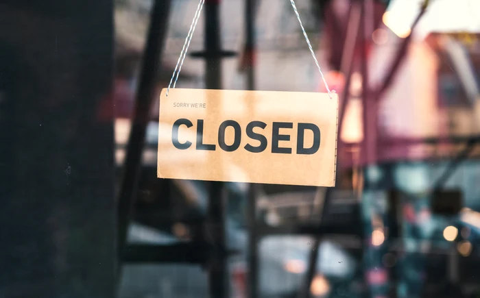 ușa unui magazin pe care scrie „Closed”