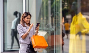 asian woman using the smart mobile phone for check online shopping order is completed with clothes beside the glassess in store shop with happy action at department center 961515078 d885f0506450479c9efb38d9ddf1ed58 jpg