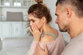 back view careful man sitting couch calm down his upset girlfriend which crying home jpg