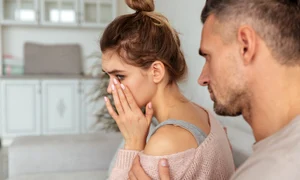 back view careful man sitting couch calm down his upset girlfriend which crying home jpg