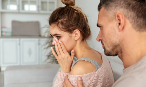 back view careful man sitting couch calm down his upset girlfriend which crying home jpg