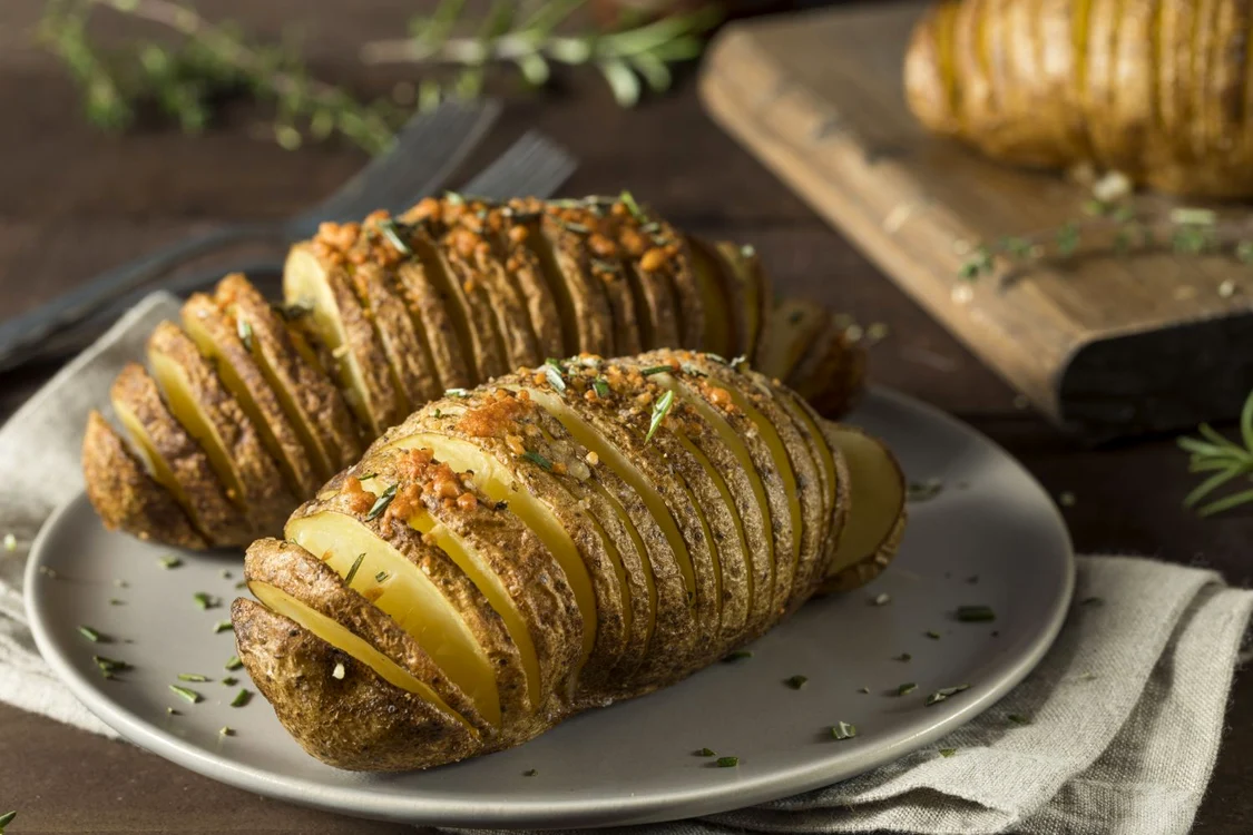 66376142   homemade cheesy hasselback potato with fresh herbs jpeg