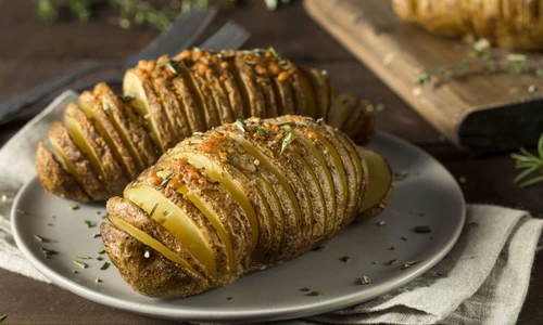 66376142   homemade cheesy hasselback potato with fresh herbs jpeg