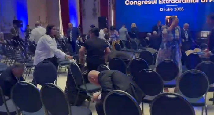 Premierul Ilie Bolojan, strângând gunoaiele din sala Congresului PNL. Sursă foto: captură video