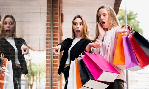 surprised girls with shopping bags looking window jpg