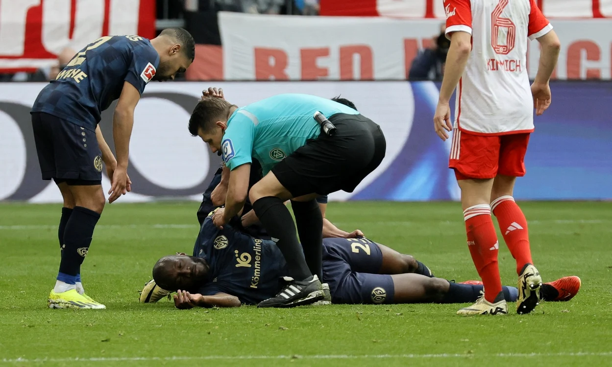 Arbitrul Ittich, primul care i-a sărit în ajutor fotbalistului. Foto EPA EFE