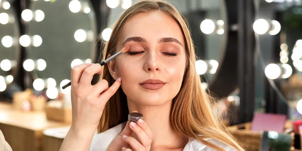 make up artist applying eyeshadow woman jpg