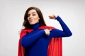 confident caucasian superhero girl with red cape tenses points biceps white jpg