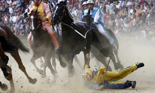 Un călăreţ cade în timpul tradiţionalei curse de cai Palio di Siena