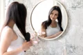 beautiful woman arranging herself mirror jpg