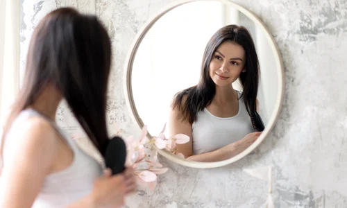 beautiful woman arranging herself mirror jpg