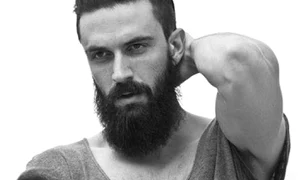 a picture of a hipster male with a classic slicked back hairstyle and a full beard style jpeg