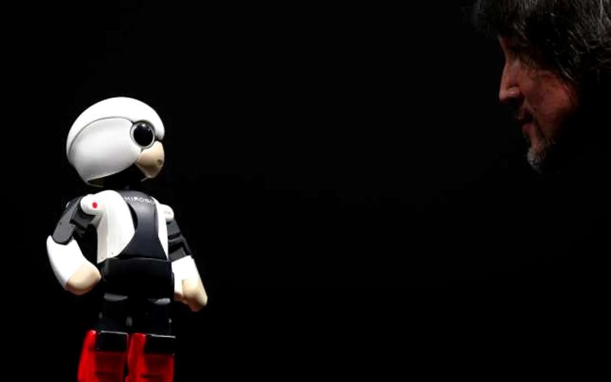 Robotul Kirobo şi unul dintre „creator“, Fuminori Kataoka, manager general pentru planificarea produselor la Toyota. FOTO Reuters