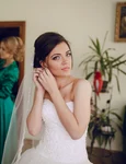 bride putting earrings jpg