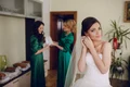 bride putting earrings jpg