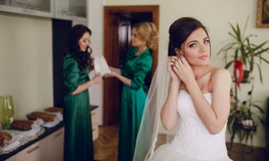 bride putting earrings jpg