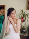 bride putting earrings jpg