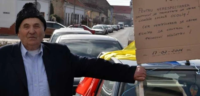 Fostul primar s-a ”inarmat” cu o pancarta si un steag tricolor. Foto: ziarulunirea.ro