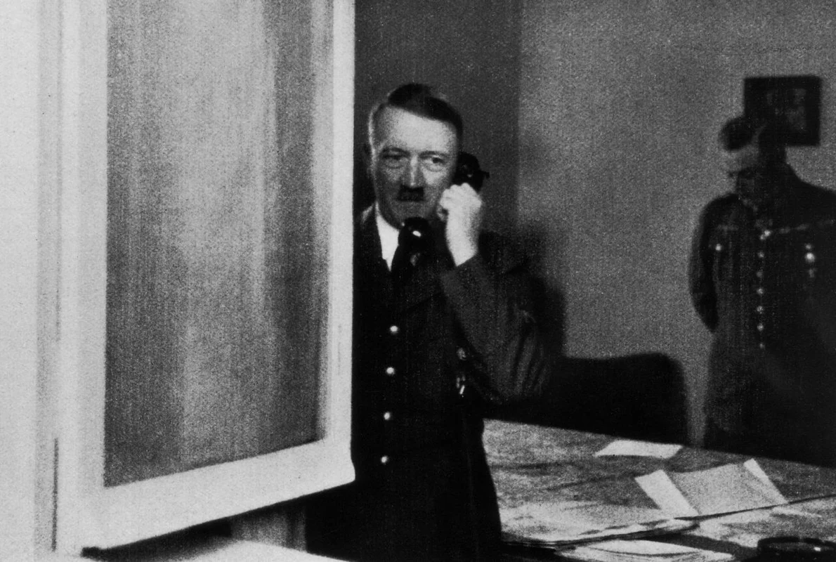 Dictatorul nazist Adolf Hitler preia un apel telefonic la Wolfsschlucht I, sediul său central din Bruly-de-Pesche, în timpul campaniei din vest, mai-iunie 1940 (© Getty Images)