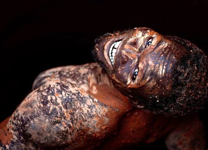 Un miner zâmbeşte în timp ce coboară într-o mină de aur din Africa de Sud, 18 septembrie (Foto: Reuters / Goran Tomasevic)