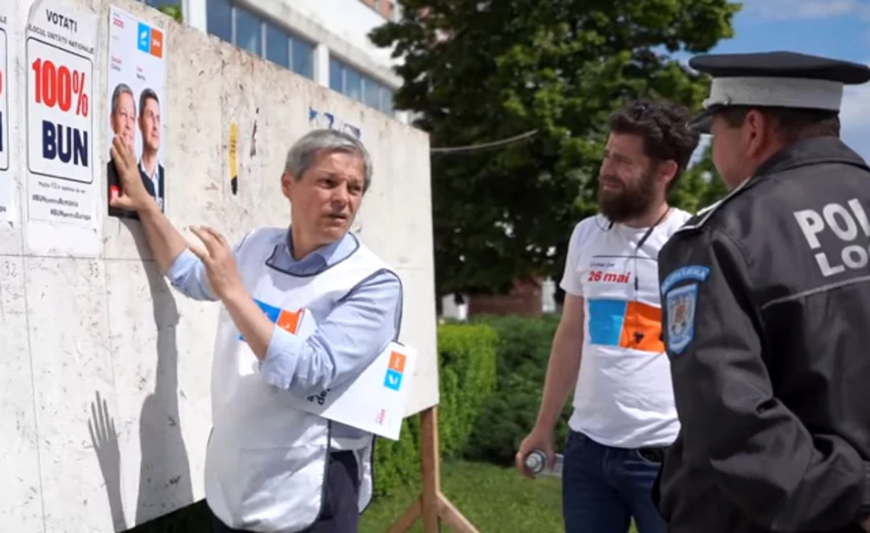 Dacian Cioloș a fost chestionat de un polițist din Alexandria pe tema afișelor electoraleFoto: captură video Facebook