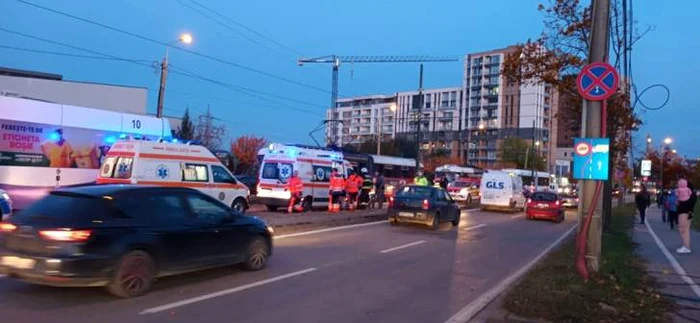 două mașini de salvare parcate pe linia de tramvai acordând primul ajutor