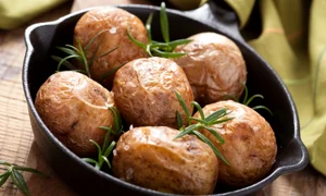 baked potatoes with rosemary in black pan jpeg