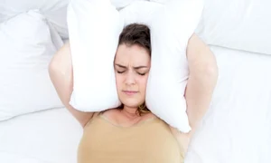 dissatisfied lady covering ears with pillow in bed 1262 6084 0 jpeg