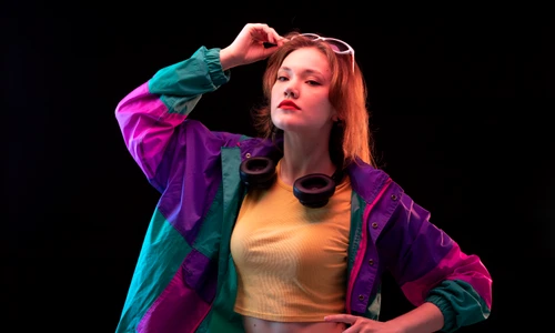 front view young modern woman colorful coat orange t shirt with black earphones sunglasses posing jpg