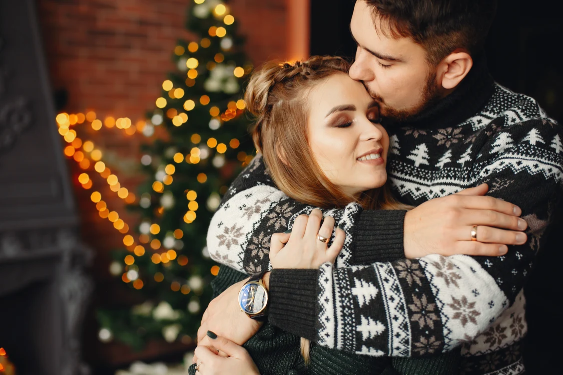 cute family standing near christmas tree jpg