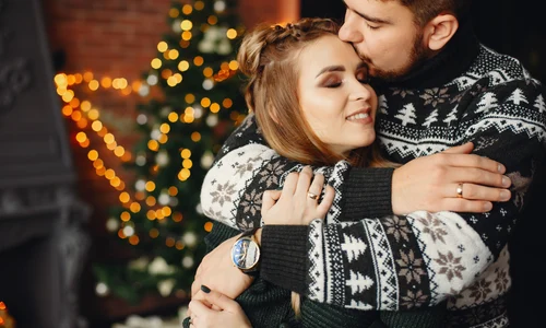 cute family standing near christmas tree jpg