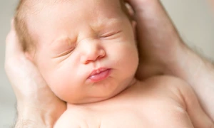 portrait newborn hold palms jpg