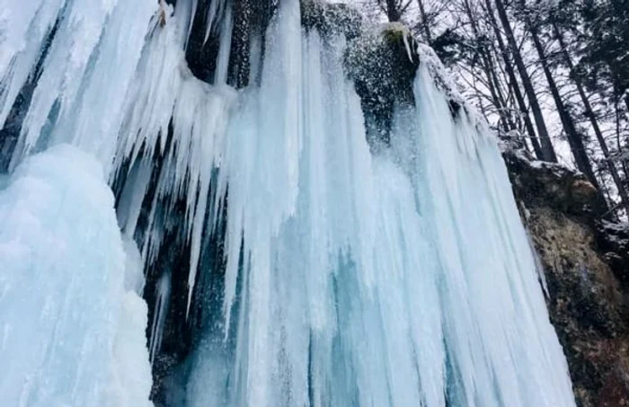 Cascada Pişoaia a îngheţat şi a devenit atracţie pentru turişti şi iarna