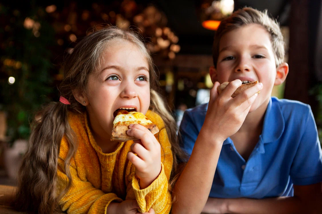 medium shot smiley kids eating pizza jpg