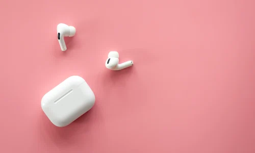 wireless inear headphones with case pink background flat lay jpg