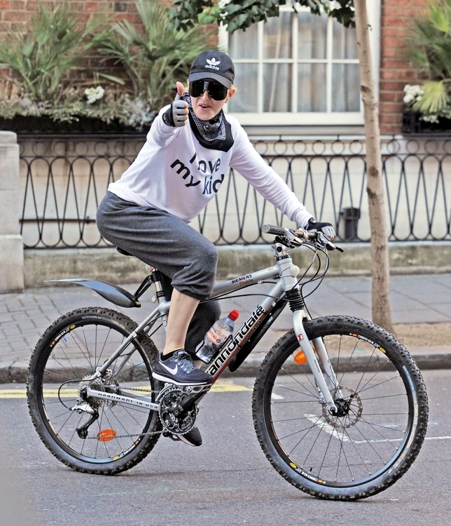 *EXCLUSIVE* WEB MUST CALL FOR PRICING Superstar Singer Madonna pictured back in London! The singer was out enjoying the Heatwave as she's seen on her Bike with family and friends jpeg