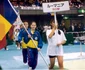 Andreea răducan purtând steagul României la o competiție sportivă