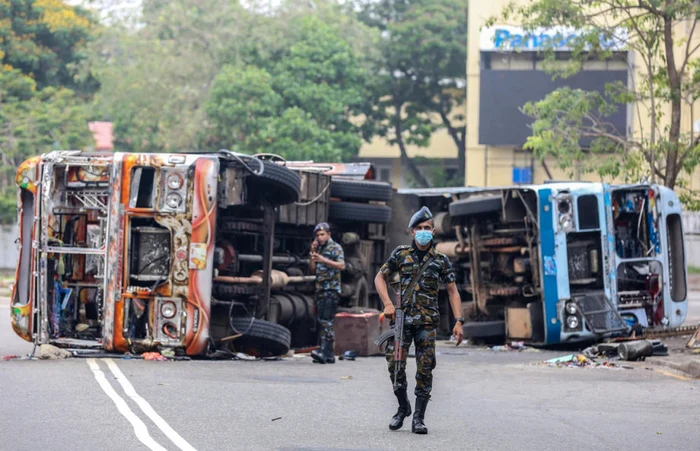 Militari srilankezi în faţa unor autpbuze incendiate de protestatari FOTO EPA-EFE