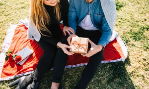 cheerful young couple with anniversary present jpg