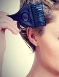 woman is coloring her hair at home jpeg